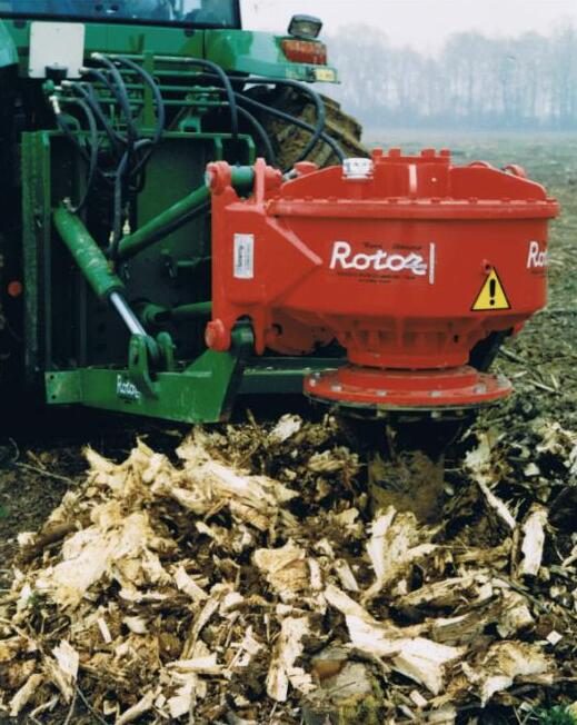 Stump grinder chewing a tree stump below grade